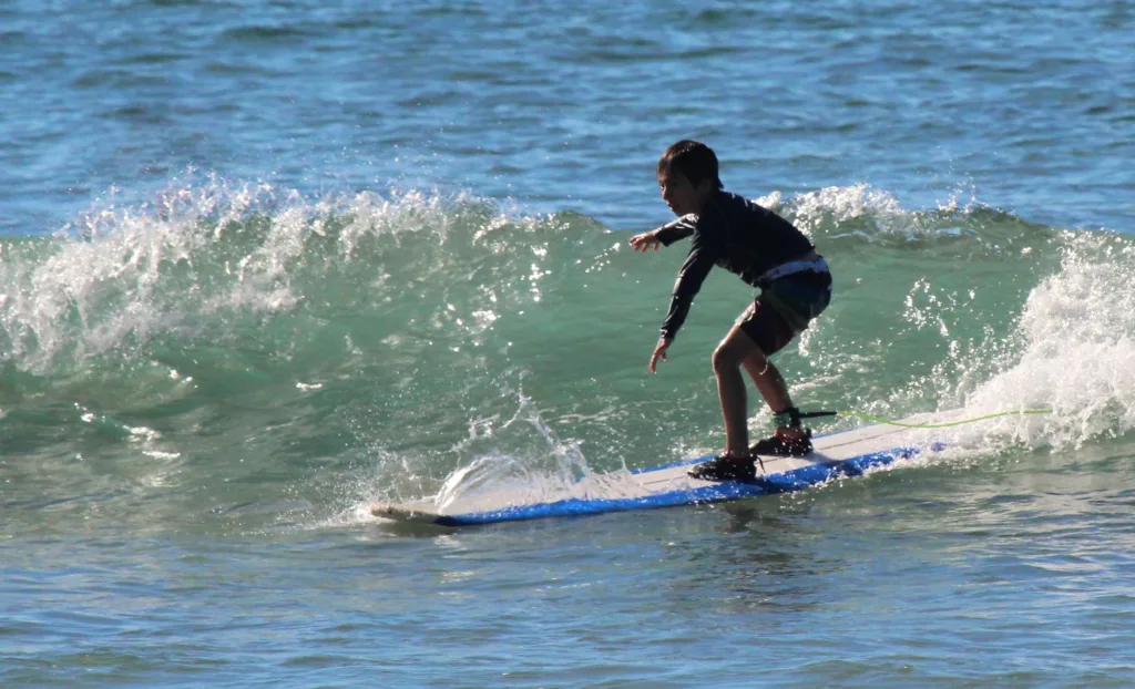 Instructor teaching surfing techniques on Maui beach