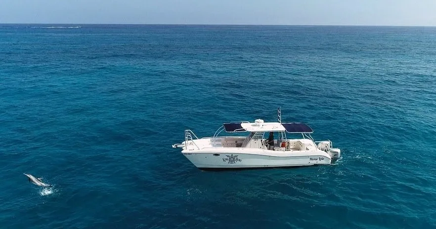 Scuba divers preparing gear on boat for two-tank dive