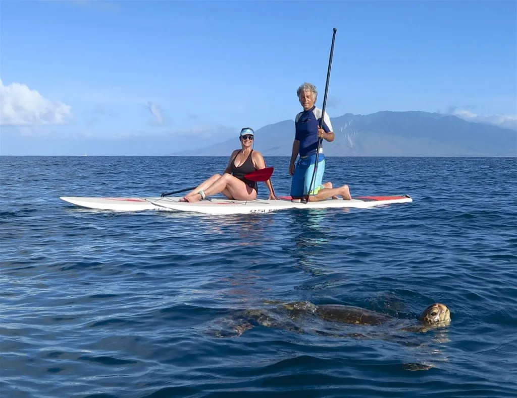 Paddleboarders enjoying calm waters on Maui island tour