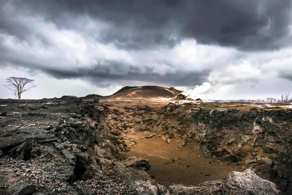 Hikers trekking along volcanic landscape in Hawaii
