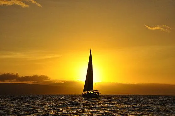 Couple enjoying private sailboat during sunset