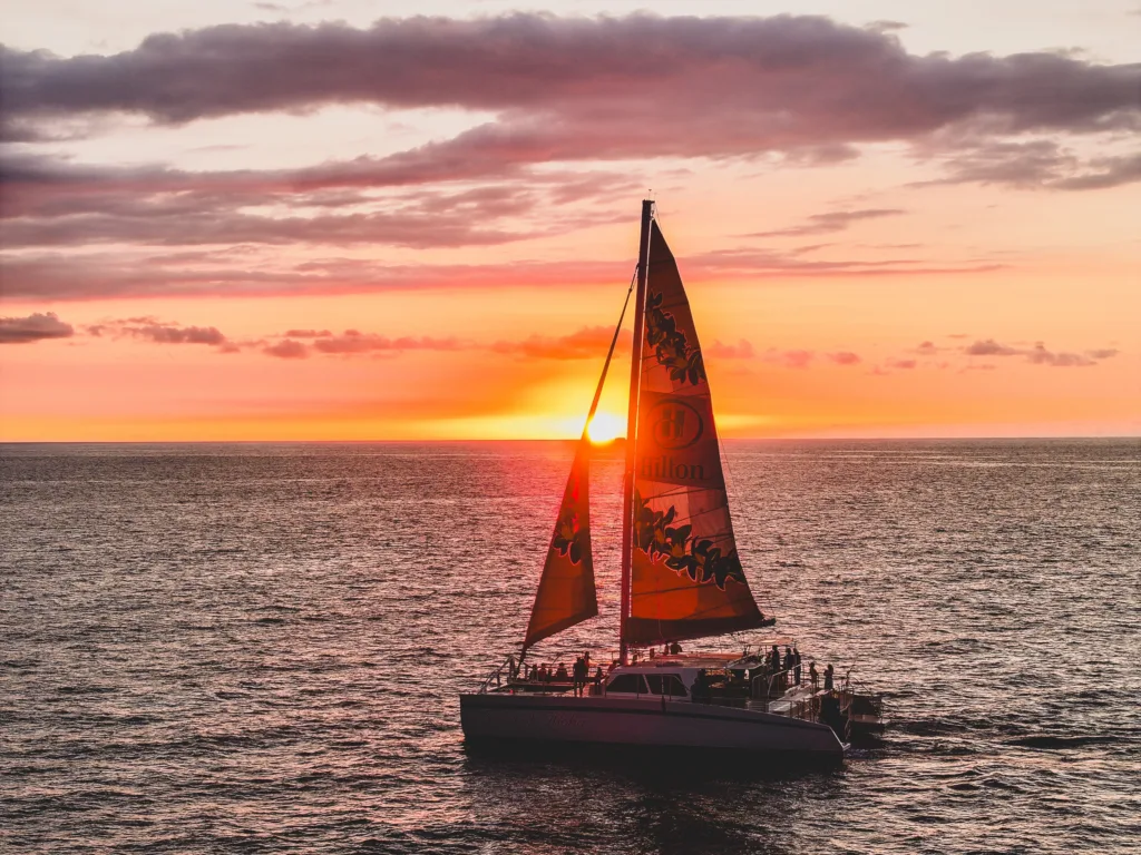 Sail along Kohala Coast during a stunning sunset cruise