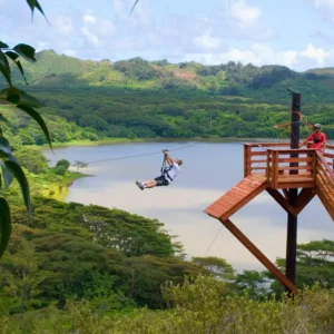 Riders soaring above lush Kauai forest canopy