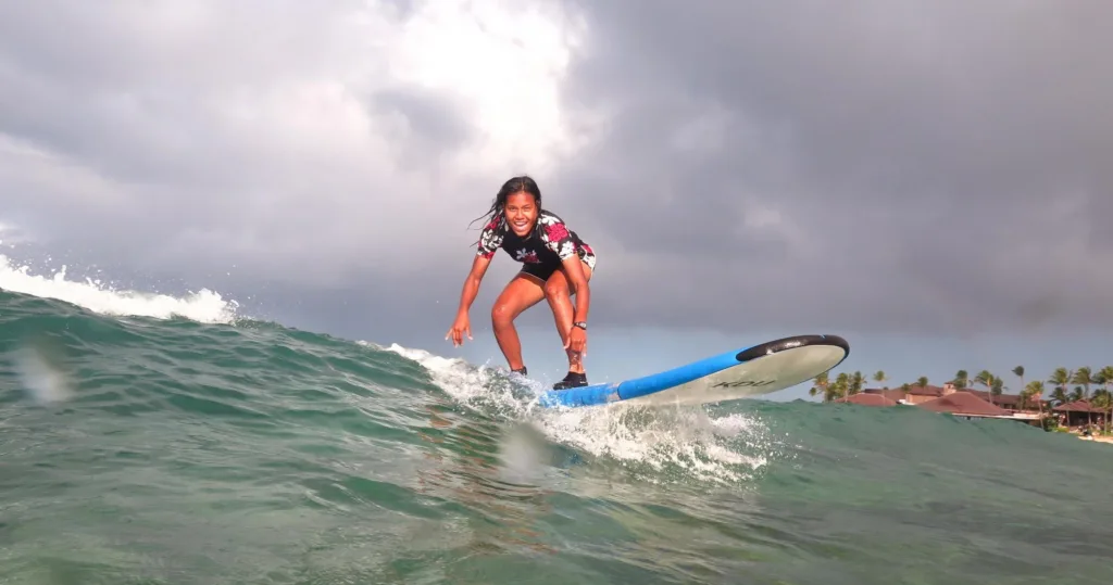Surf instructor giving private lesson to individual surfer
