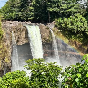 Visitors admiring cascading waterfalls on island tour