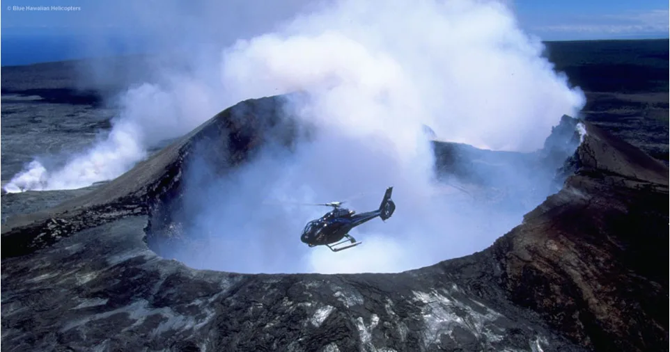 Helicopter flying over volcanic landscape near Hilo