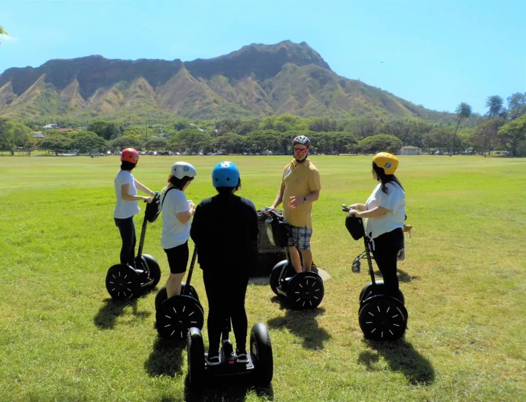 Hikers ascending Diamond Head crater trail with ocean views