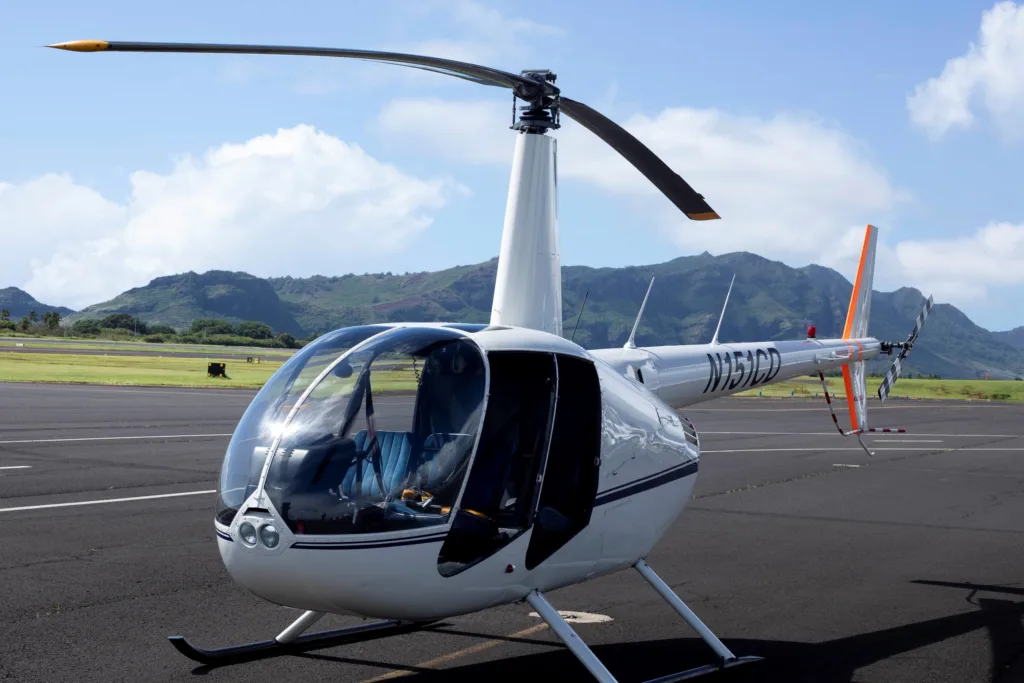 Private helicopter flying over Kauai's lush landscape
