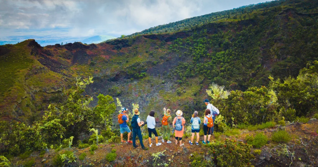 Hikers trekking through volcanic landscape on Hidden Craters