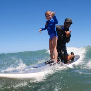 Instructor giving private surf lesson on Oahu beach