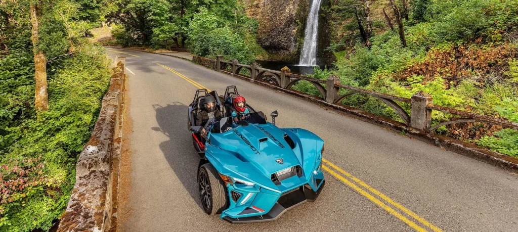 Polaris Slingshot parked near tropical island shoreline