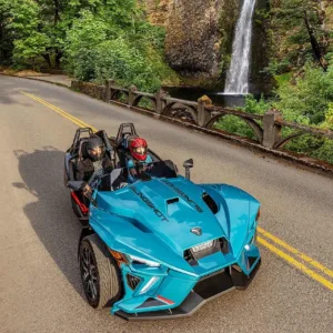 Polaris Slingshot parked near tropical island shoreline
