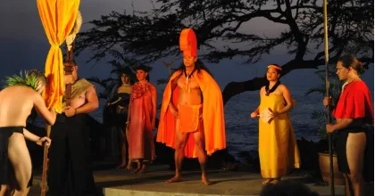 Couple seated in premium area enjoying Hawaiian luau show