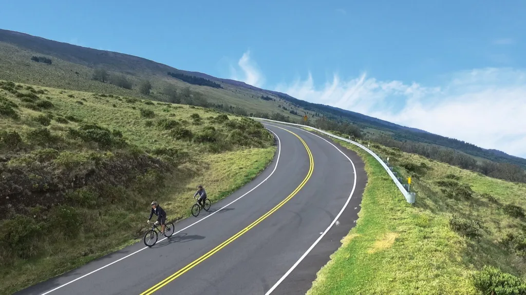 Cyclist descending scenic Haleakala slopes on self-guided tour