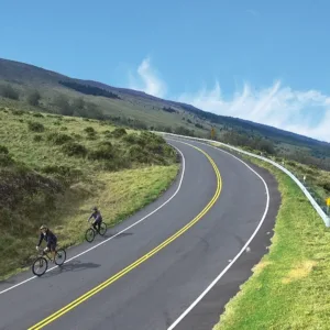 Cyclist descending scenic Haleakala slopes on self-guided tour