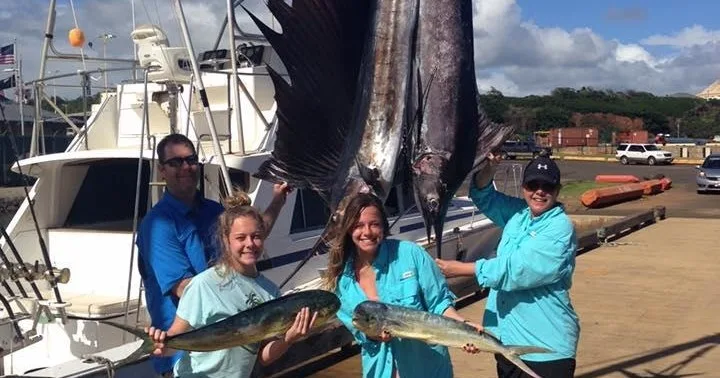 Group fishing on a shared charter boat near Kauai