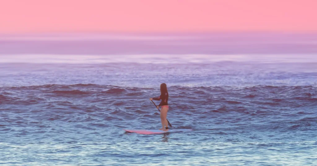 Stand up paddleboarders learning on calm water