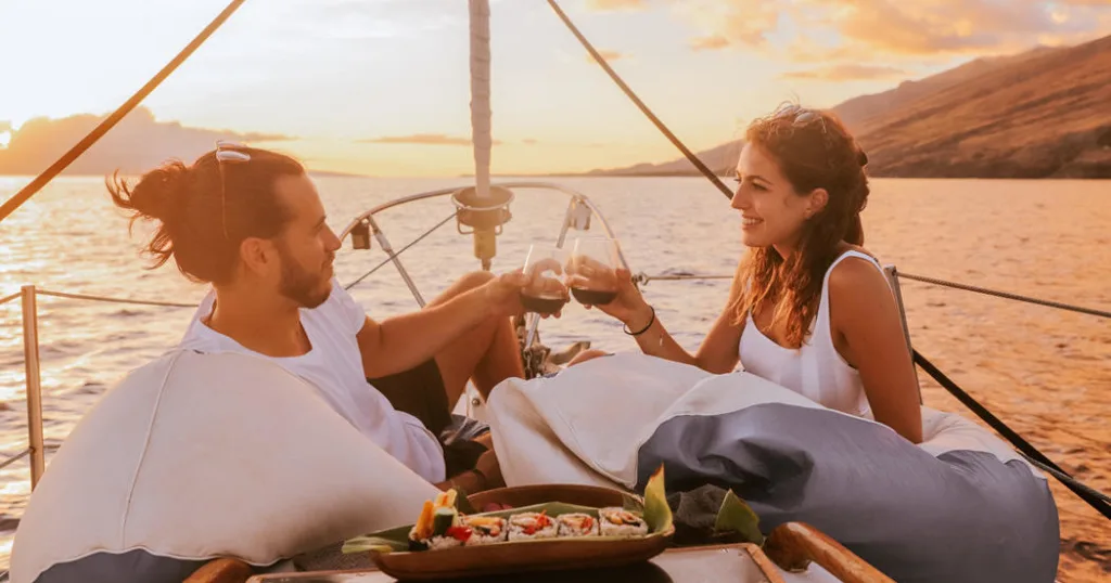 Private monohull boat cruising at sunset on the ocean