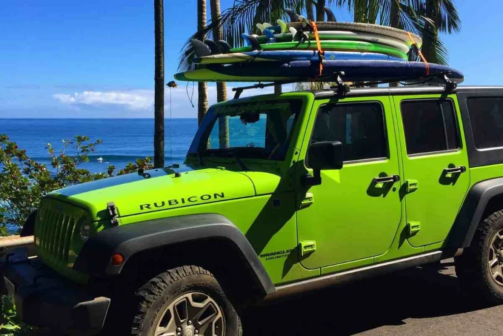 Riding waves during the Maui surf safari experience