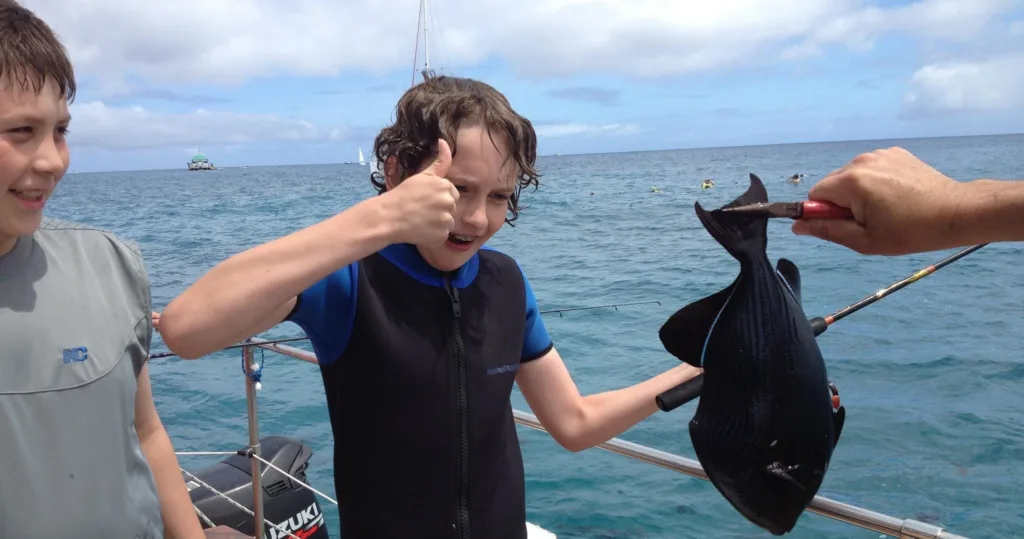 Fisherman casting lines over vibrant coral reef