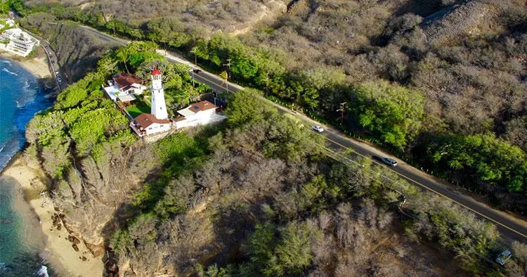 Circle island tour boat cruising along volcanic coastline