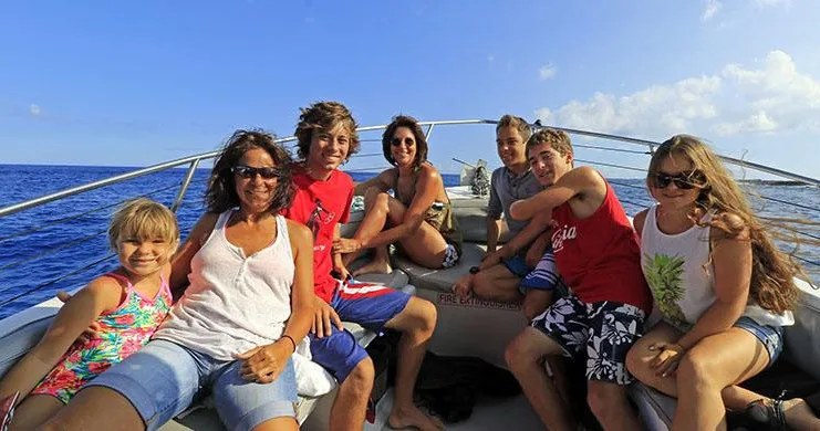 Private boat charter anchored near coral reef