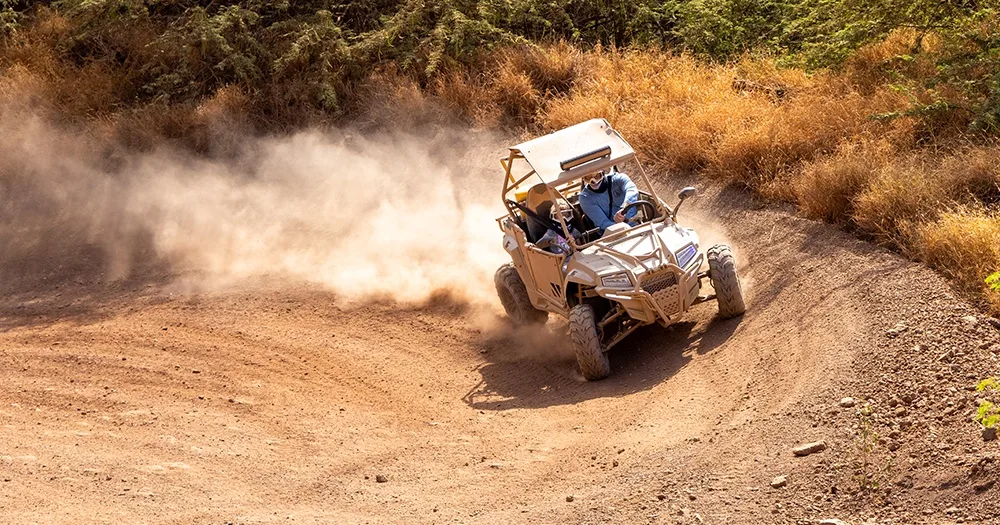 Riders navigating rugged terrain on off-road ATVs