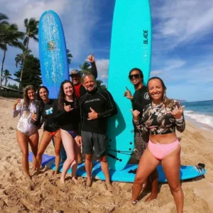 Private surf lesson with instructor helping guest catch waves