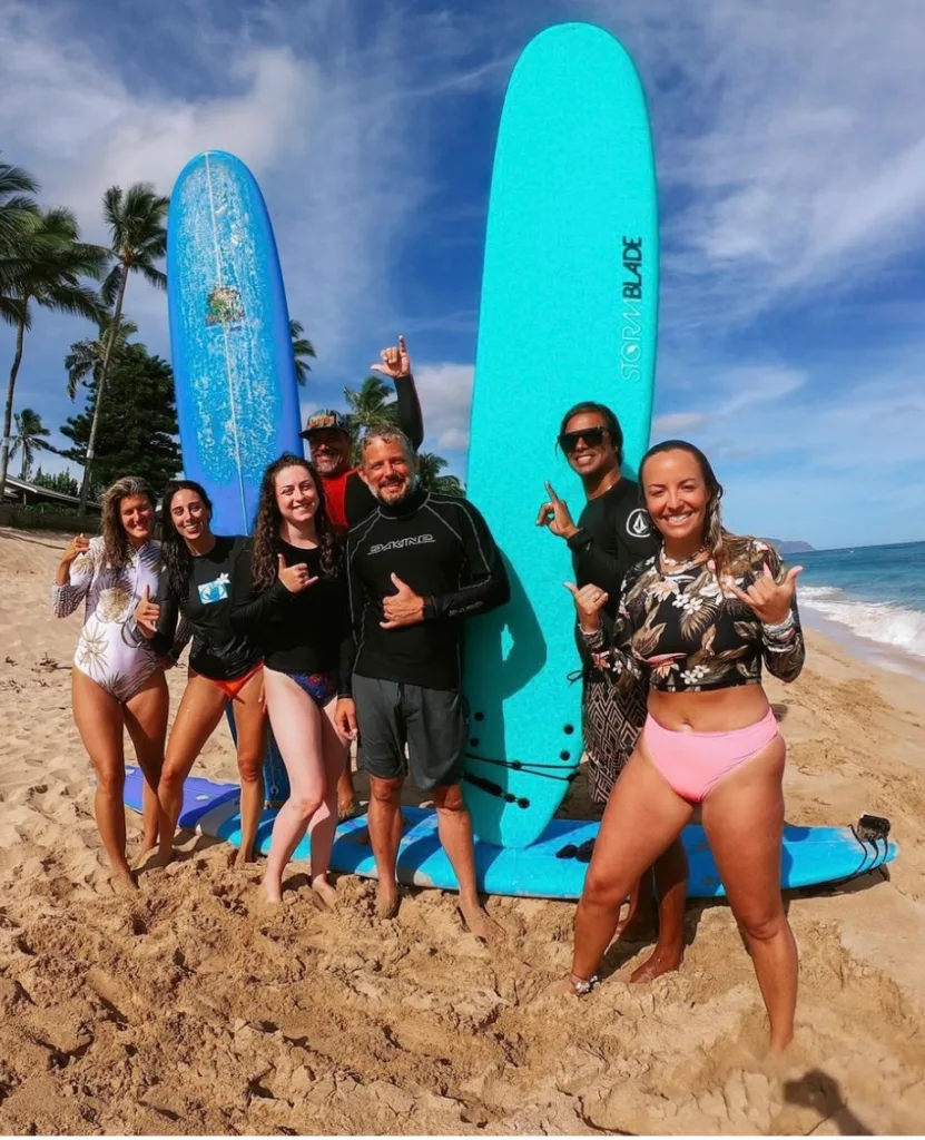 Private surf lesson with instructor helping guest catch waves