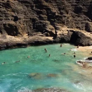 Tourists hiking along the scenic ocean coastline in Oahu