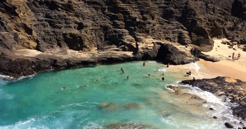 Tourists hiking along the scenic ocean coastline in Oahu