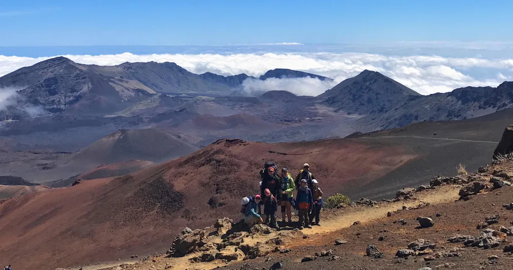 Hikers trekking on Haleakala volcanic landscape trail