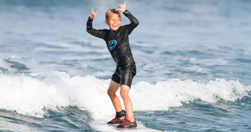 Surf instructor guiding private lesson on gentle waves