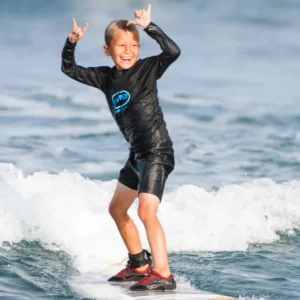 Surf instructor guiding private lesson on gentle waves