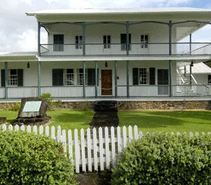 Visitors touring historic Mission House with guided explanations