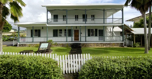 Visitors touring historic Mission House with guided explanations