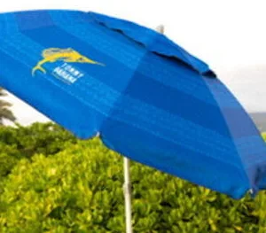 Colorful beach umbrella shading visitors on sunny shore
