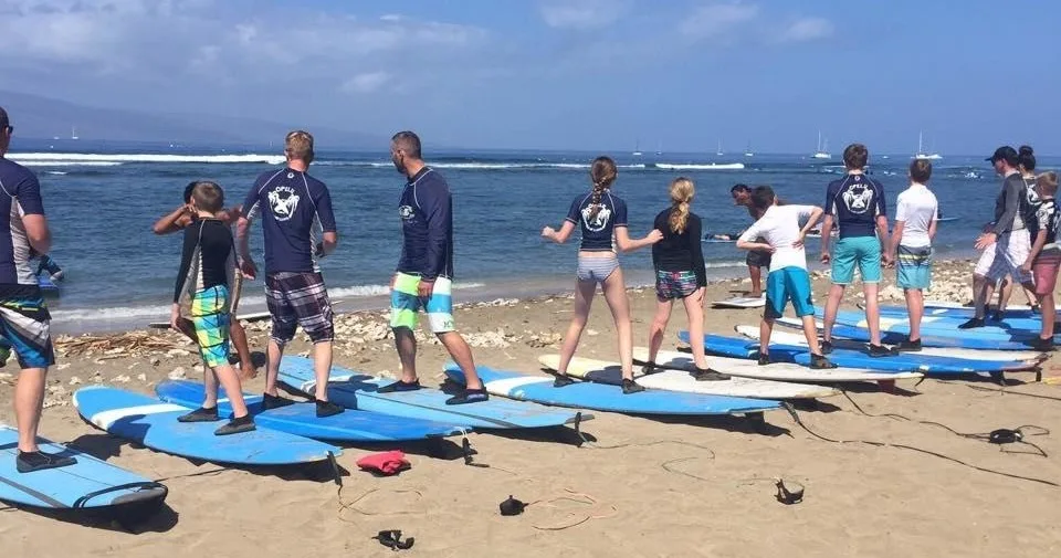 Group of beginners learning to surf together