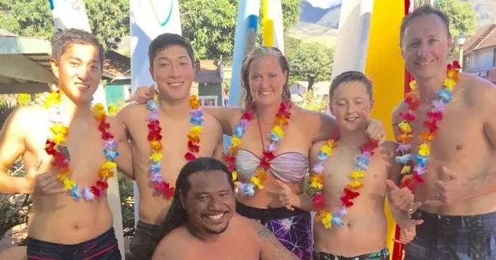 Group learning stand up paddleboarding on ocean waves