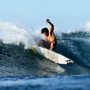 Surfer catching a wave during advanced surf lesson session
