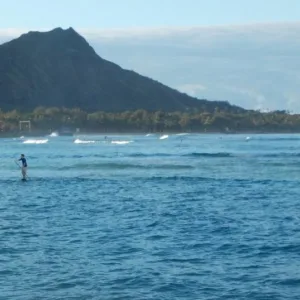 Student learning stand up paddleboarding on Waikiki beach