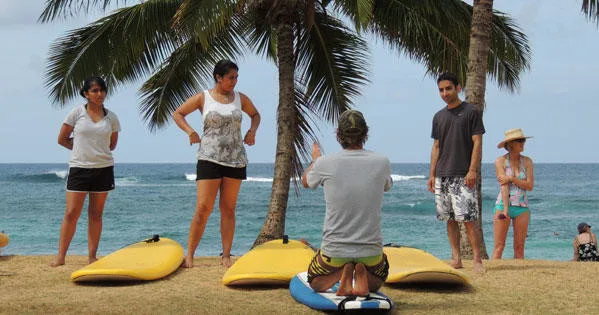 Group surf lesson with instructor guiding beginners