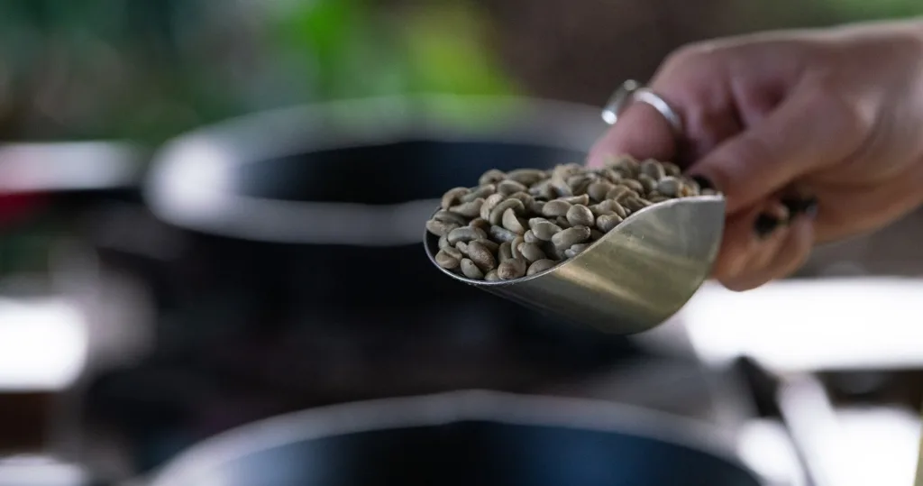 Person roasting coffee beans in a traditional Hawaiian style