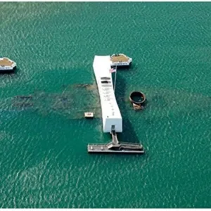 Historic USS Arizona memorial with Honolulu city backdrop
