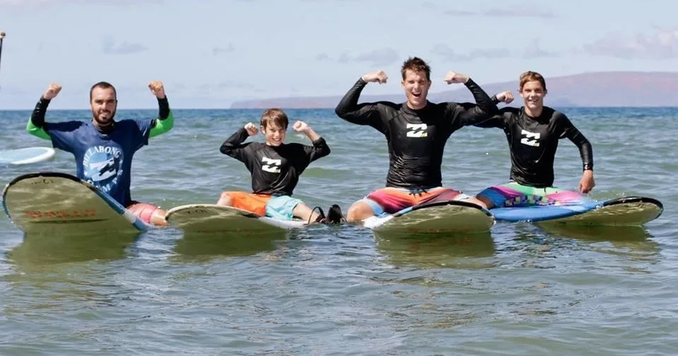 Beginner surfer catching waves at Maui surf camp