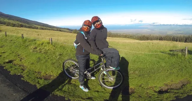 Cyclist riding down Haleakala volcano on self-guided tour