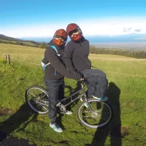 Cyclist riding down Haleakala volcano on self-guided tour