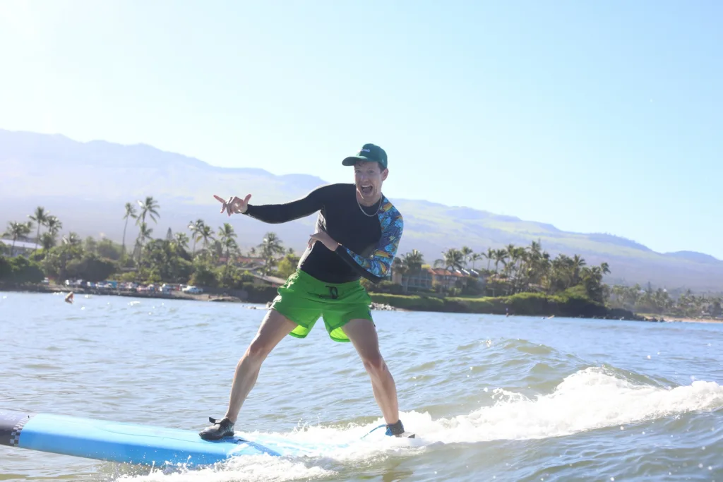 Instructor giving private surf lesson on Maui beach