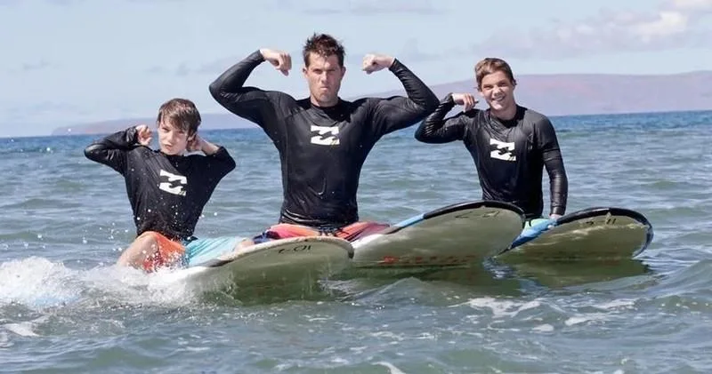Group of surfers taking lesson on Maui sandy beach