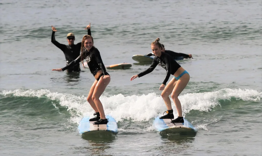 Group of surfers catching waves together in Maui